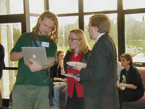 photo (70KB): Chris Gutteridge (left) talking to delegates in the break