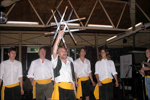 photo (55KB) : Brian Kelly giving a sword-dancing demonstration at the Workshop Barbeque - no delegates injured